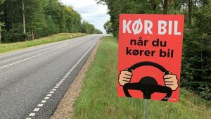 I de kommende uger vil bilisterne i Ringkøbing-Skjern Kommune møde knaldrøde plakater på udvalgte veje. Plakaterne skal minde trafikanterne om, at de skal holde øje med trafikken, når de kører bil. foto: NR